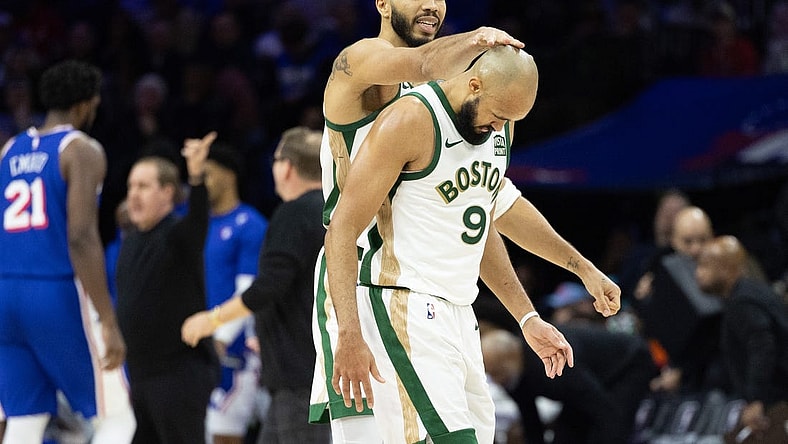 Nov 15, 2023; Philadelphia, Pennsylvania, USA; Boston Celtics forward Jayson Tatum (0) congratulates guard Derrick White (9) after his three pointer against the Philadelphia 76ers during the fourth quarter at Wells Fargo Center. Mandatory Credit: Bill Streicher-USA TODAY Sports