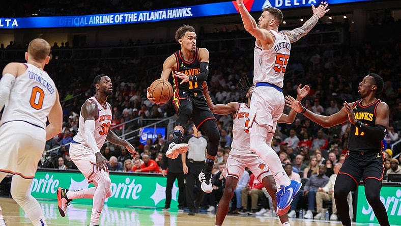 Nov 15, 2023; Atlanta, Georgia, USA; Atlanta Hawks guard Trae Young (11) passes around New York Knicks center Isaiah Hartenstein (55) in the second half at State Farm Arena. Mandatory Credit: Brett Davis-USA TODAY Sports