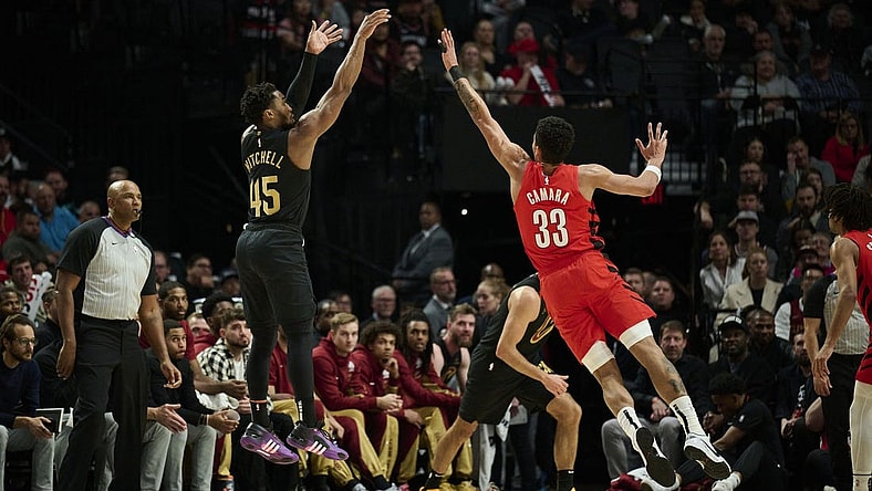 Nov 15, 2023; Portland, Oregon, USA; Cleveland Cavaliers guard Donovan Mitchell (45) shoots a basket during the first half against Portland Trail Blazers forward Toumani Camara (33) at Moda Center. Mandatory Credit: Troy Wayrynen-USA TODAY Sports