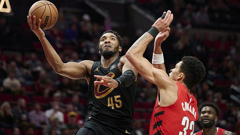 Nov 15, 2023; Portland, Oregon, USA; Cleveland Cavaliers guard Donovan Mitchell (45) drives to the basket during the second half against Portland Trail Blazers forward Toumani Camara (33) at Moda Center. Mandatory Credit: Troy Wayrynen-USA TODAY Sports