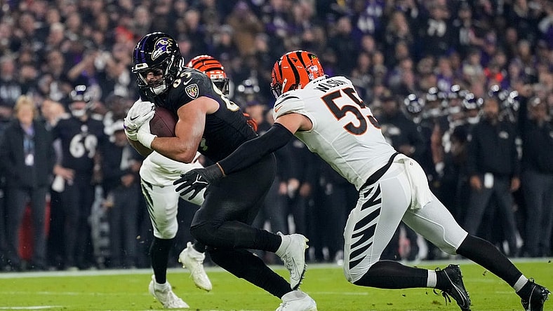 Baltimore Ravens tight end Mark Andrews (89) fights a tackle from Cincinnati Bengals linebacker Logan Wilson (55) in the first quarter of the NFL Week 11 game between the Baltimore Ravens and the Cincinnati Bengals at M&T Bank Stadium in Baltimore on Thursday, Nov. 16, 2023.