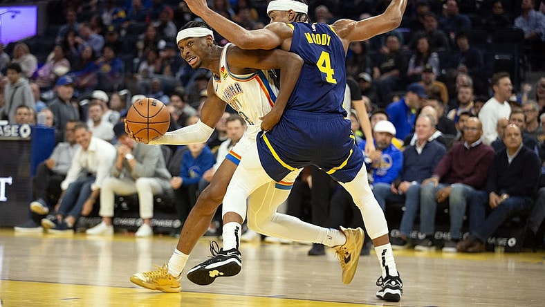 Nov 16, 2023; San Francisco, California, USA; Oklahoma City Thunder guard Shai Gilgeous-Alexander (2) commits an offensive foul on Golden State Warriors guard Moses Moody (4) during the second quarter at Chase Center. Mandatory Credit: D. Ross Cameron-USA TODAY Sports