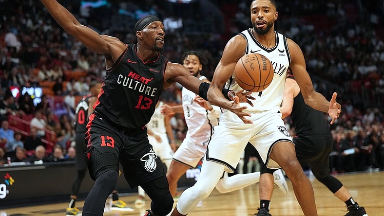Nov 16, 2023; Miami, Florida, USA; Miami Heat center Bam Adebayo (13) tips the ball away from Brooklyn Nets forward Mikal Bridges (1) in the second half at Kaseya Center. Mandatory Credit: Jim Rassol-USA TODAY Sports