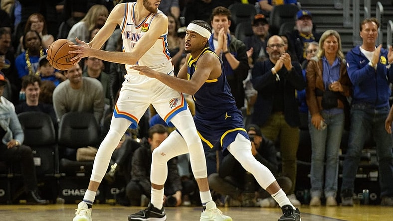 Nov 16, 2023; San Francisco, California, USA; Oklahoma City Thunder center Chet Holmgren (7) looks to pass around Golden State Warriors guard Moses Moody (4) during the third quarter at Chase Center. Mandatory Credit: D. Ross Cameron-USA TODAY Sports