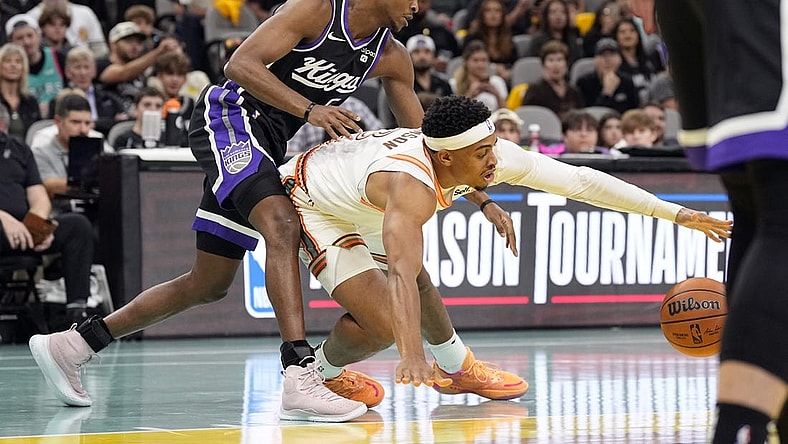 Nov 17, 2023; San Antonio, Texas, USA; Sacramento Kings guard De'Aaron Fox (5) and and San Antonio Spurs forward Keldon Johnson (3) battle for the loose ball during the first half at Frost Bank Center. Mandatory Credit: Scott Wachter-USA TODAY Sports