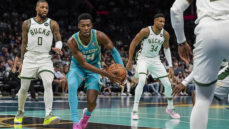 Nov 17, 2023; Charlotte, North Carolina, USA; Charlotte Hornets forward Brandon Miller (24) recovers the ball defended by Milwaukee Bucks guard Damian Lillard (0) during the first quarter at the Spectrum Center. Mandatory Credit: Jim Dedmon-USA TODAY Sports