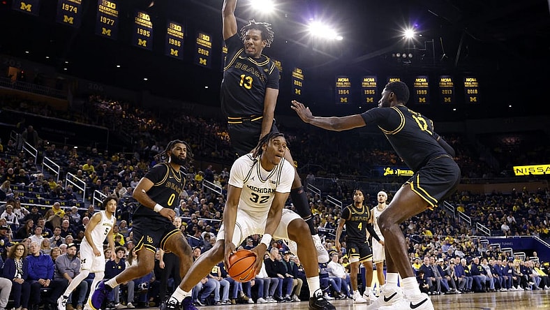 Nov 17, 2023; Ann Arbor, Michigan, USA; Michigan Wolverines forward Tarris Reed Jr. (32) is defended by Long Beach State 49ers center Chayce Polynice (13) in the first half at Crisler Center. Mandatory Credit: Rick Osentoski-USA TODAY Sports