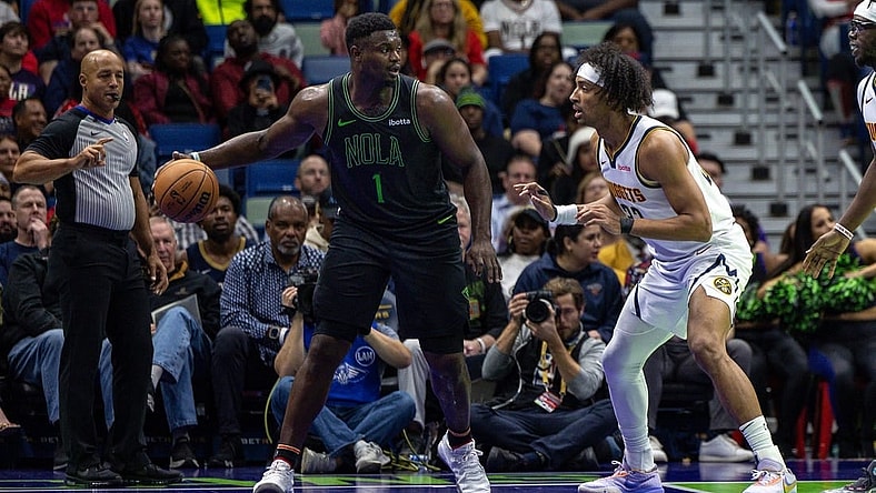 Nov 17, 2023; New Orleans, Louisiana, USA;  New Orleans Pelicans forward Zion Williamson (1) dribbles against Denver Nuggets forward Zeke Nnaji (22) during the first half at the Smoothie King Center. Mandatory Credit: Stephen Lew-USA TODAY Sports
