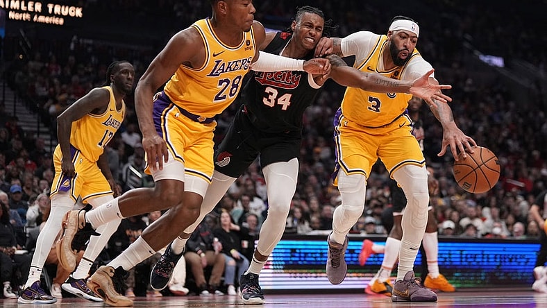 Nov 17, 2023; Portland, Oregon, USA; Portland Trail Blazers forward Jabari Walker (34) and Los Angeles Lakers power forward Rui Hachimura (28) and Anthony Davis (3) go after a loose ball during the first half at Moda Center. Mandatory Credit: Soobum Im-USA TODAY Sports