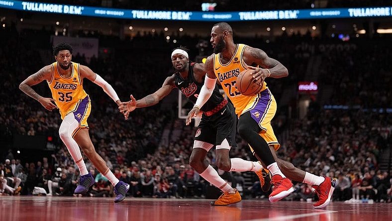 Nov 17, 2023; Portland, Oregon, USA; Los Angeles Lakers small forward LeBron James (23) dribbles the ball while defended by Portland Trail Blazers small forward Jerami Grant (9) during the second half at Moda Center. Mandatory Credit: Soobum Im-USA TODAY Sports