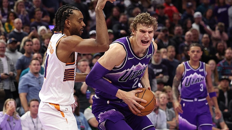 Nov 17, 2023; Salt Lake City, Utah, USA; Utah Jazz forward Lauri Markkanen (23) goes to the basket against Phoenix Suns forward Keita Bates-Diop (21) in the fourth quarter at Delta Center. Mandatory Credit: Rob Gray-USA TODAY Sports
