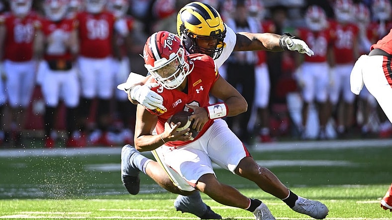 Nov 18, 2023; College Park, Maryland, USA; Michigan Wolverines defensive end Jaylen Harrell (32) sacks Maryland Terrapins quarterback Taulia Tagovailoa (3) during the first half at SECU Stadium. Mandatory Credit: Brad Mills-USA TODAY Sports
