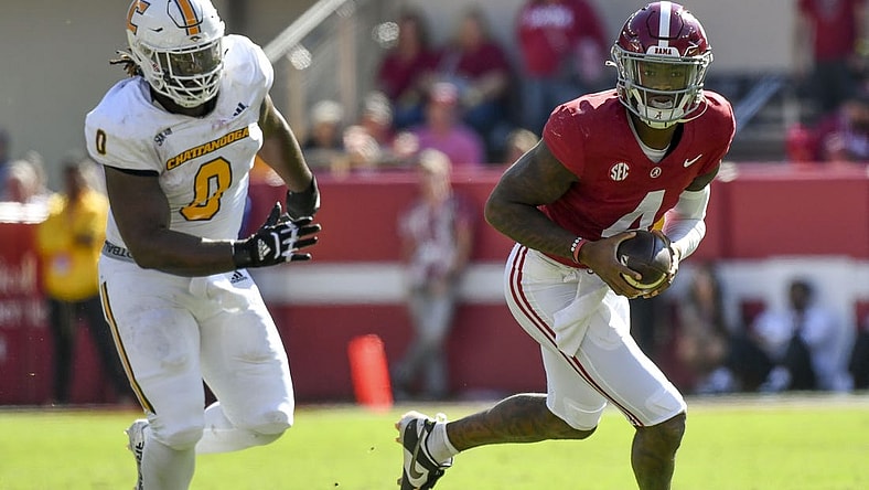 Nov 18, 2023; Tuscaloosa, Alabama, USA;  Alabama Crimson Tide quarterback Jalen Milroe (4) rolls out with Chattanooga Mocs defensive lineman Quay Wiggles (0) giving chase at Bryant-Denny Stadium. Mandatory Credit: Gary Cosby Jr.-USA TODAY Sports