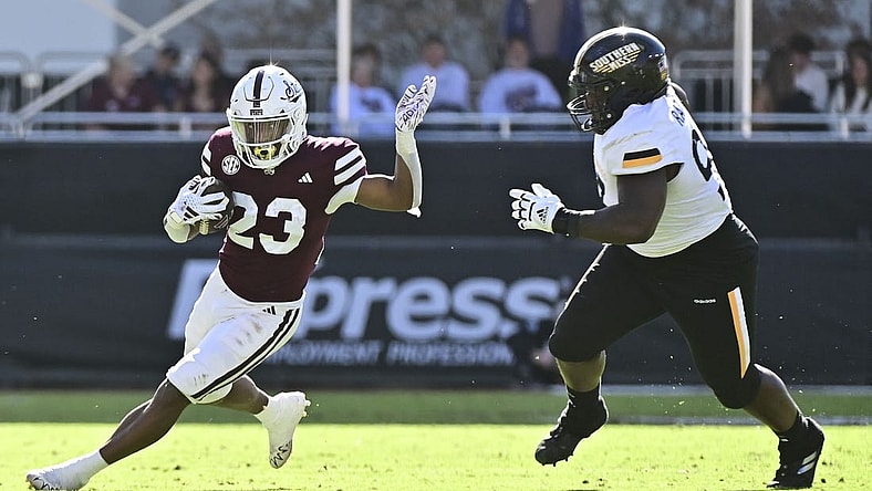 Nov 18, 2023; Starkville, Mississippi, USA; Mississippi State Bulldogs running back Seth Davis (23) runs the ball while defended by Southern Miss Golden Eagles defensive tackle Josh Ratcliff (93) during the second quarter at Davis Wade Stadium at Scott Field. Mandatory Credit: Matt Bush-USA TODAY Sports