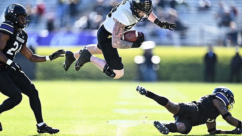 Nov 18, 2023; Evanston, Illinois, USA;  Purdue Boilermakers tight end Garrett Miller (88) is tripped up by Northwestern Wildcats defensive back Jaheem Joseph (3) after a pass reception in the second quarter at Ryan Field. Mandatory Credit: Jamie Sabau-USA TODAY Sports