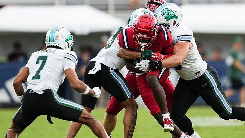 Nov 18, 2023; Boca Raton, Florida, USA; Florida Atlantic Owls wide receiver Tony Johnson (0) is tackled while running the ball against the Tulane Green Wave the first half at FAU Stadium. Mandatory Credit: Jim Rassol-USA TODAY Sports