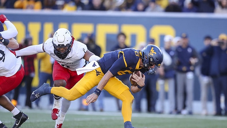 Nov 18, 2023; Morgantown, West Virginia, USA; West Virginia Mountaineers quarterback Garrett Greene (6) runs the ball for a touchdown during the first quarter against the Cincinnati Bearcats at Mountaineer Field at Milan Puskar Stadium. Mandatory Credit: Ben Queen-USA TODAY Sports
