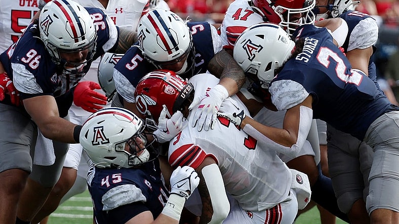 Nov 18, 2023; Tucson, Arizona, USA; Utah Utes running back Ja'Quinden Jackson (3) is tackled by Arizona Wildcats defensive lineman Bill Norton (45) and linebacker Jacob Manu (5) during the first half at Arizona Stadium. Mandatory Credit: Zachary BonDurant-USA TODAY Sports