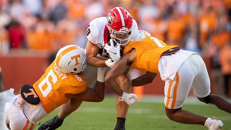 Georgia tight end Brock Bowers (19) is tackled by Tennessee linebacker Aaron Beasley (6) during a football game between Tennessee and Georgia at Neyland Stadium in Knoxville, Tenn., on Saturday, Nov. 18, 2023.