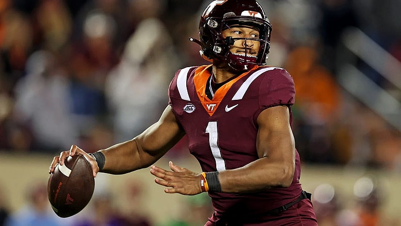 Nov 18, 2023; Blacksburg, Virginia, USA; Virginia Tech Hokies quarterback Kyron Drones (1) throws a pass during the fourth quarter against the North Carolina State Wolfpack at Lane Stadium. Mandatory Credit: Peter Casey-USA TODAY Sports