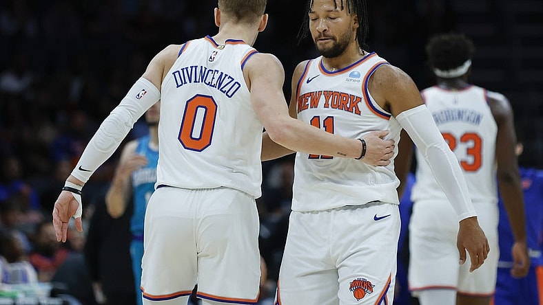 Nov 18, 2023; Charlotte, North Carolina, USA; New York Knicks guard Jalen Brunson (11) embraces guard Donte DiVincenzo (0) during the first quarter against the Charlotte Hornets at Spectrum Center. Mandatory Credit: Nell Redmond-USA TODAY Sports