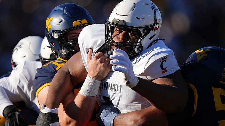 Nov 18, 2023; Morgantown, West Virginia, USA; Cincinnati Bearcats defensive lineman Dontay Corleone (2) is double-teamed on a pass rush against the West Virginia Mountaineers in the first quarter at Milan Puskar Stadium.  Mandatory Credit: Kareem Elgazzar-USA TODAY Sports