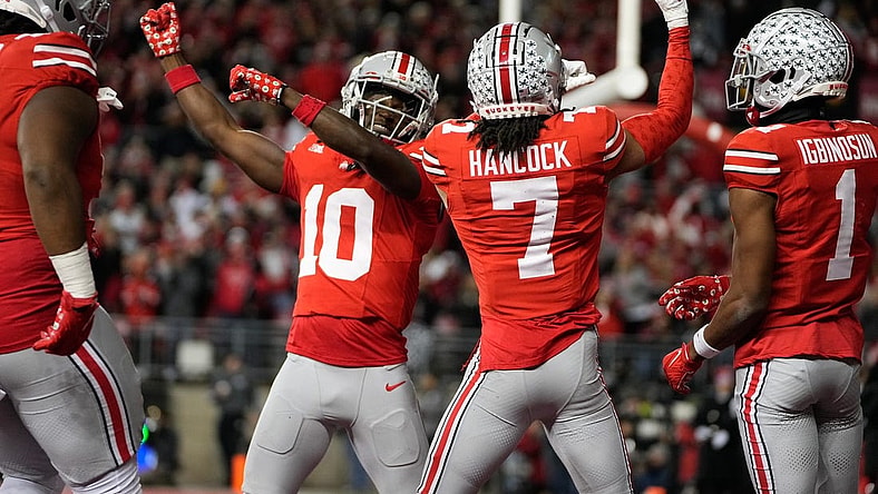 Nov 18, 2023; Columbus, Ohio, USA; Ohio State Buckeyes cornerback Jordan Hancock (7) and cornerback Denzel Burke (10) celebrate an interception by Hancock during the second half of the NCAA football game against the Minnesota Golden Gophers at Ohio Stadium. Ohio State won 37-3.