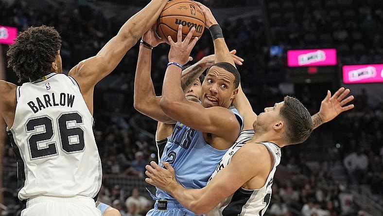 Nov 18, 2023; San Antonio, Texas, USA; Memphis Grizzlies guard Desmond Bane (22) looks to pass the ball while defended by San Antonio Spurs forwards Dom Barlow (26) and Doug McDermott (17) during the second half at Frost Bank Center. Mandatory Credit: Scott Wachter-USA TODAY Sports