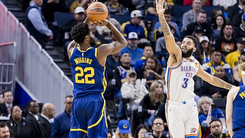 Nov 18, 2023; San Francisco, California, USA; Golden State Warriors forward Andrew Wiggins (22) takes a three-point shot as Oklahoma City Thunder guard Josh Giddey (3) defends during the first half at Chase Center. Mandatory Credit: John Hefti-USA TODAY Sports