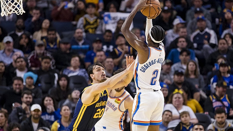 Nov 18, 2023; San Francisco, California, USA; Golden State Warriors center Dario Saric (20) defends Oklahoma City Thunder guard Shai Gilgeous-Alexander (2) during the second half at Chase Center. Mandatory Credit: John Hefti-USA TODAY Sports