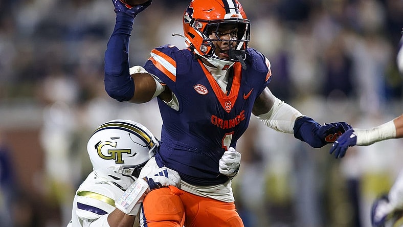 Nov 18, 2023; Atlanta, Georgia, USA; Syracuse Orange running back LeQuint Allen (1) is pressured by Georgia Tech Yellow Jackets linebacker Trenilyas Tatum (7) in the second half at Bobby Dodd Stadium at Hyundai Field. Mandatory Credit: Brett Davis-USA TODAY Sports