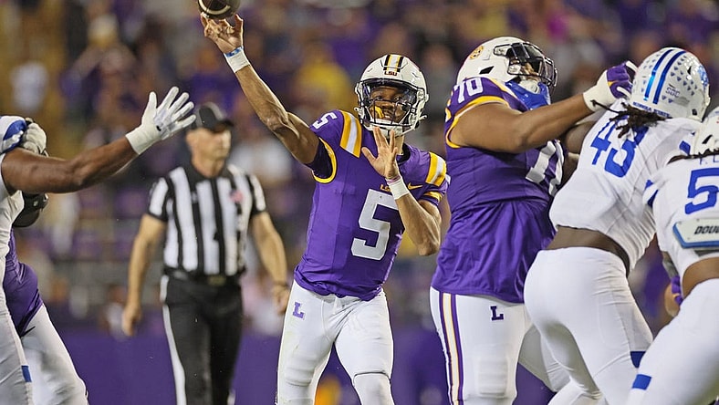 Nov 18, 2023; Baton Rouge, Louisiana, USA; LSU Tigers quarterback Jayden Daniels (5) throws a pass in the third quarter as offensive lineman Miles Frazier (70) blocks Georgia State Panthers linebacker Chris Davis Jr. (43) at Tiger Stadium. Mandatory Credit: Matthew Dobbins-USA TODAY Sports