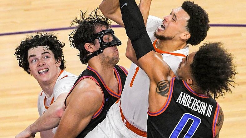 Sunday, November 19, 2023; Clemson senior guard Chase Hunter (1) scores near Boise State forward Tyson Degenhart (2) during the first half at Littlejohn Coliseum in Clemson, S.C. Sunday, November 19, 2023.  Mandatory Credit: Ken Ruinard-USA TODAY NETWORK