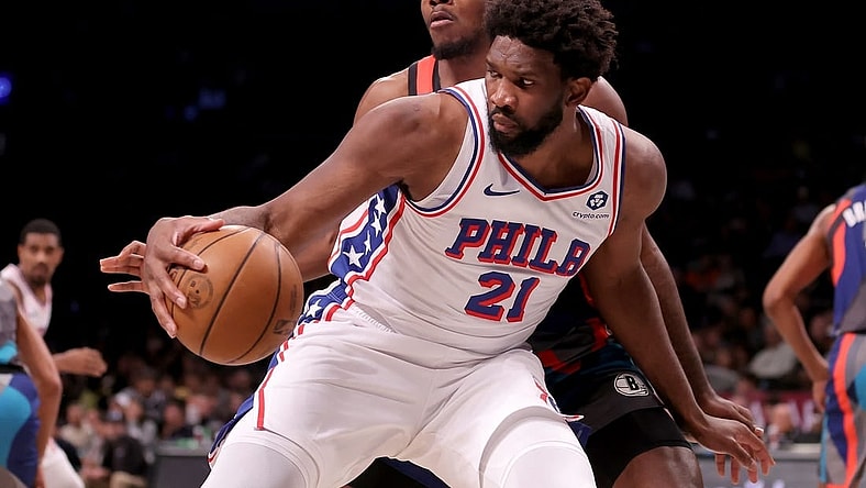 Nov 19, 2023; Brooklyn, New York, USA; Philadelphia 76ers center Joel Embiid (21) controls the ball against Brooklyn Nets center Day'Ron Sharpe (20) during the second quarter at Barclays Center. Mandatory Credit: Brad Penner-USA TODAY Sports