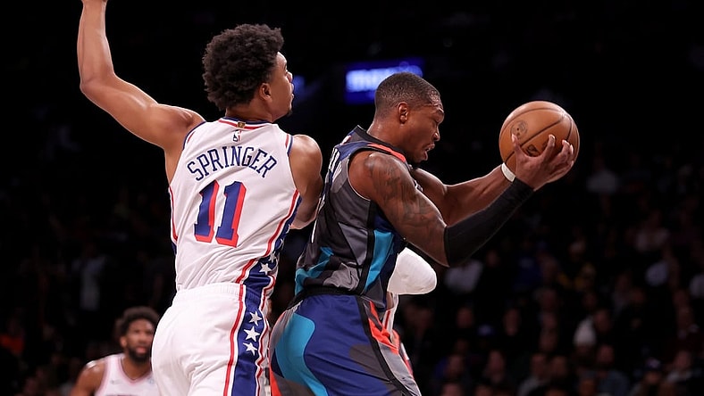 Nov 19, 2023; Brooklyn, New York, USA; Brooklyn Nets guard Lonnie Walker IV (8) grabs a rebound against Philadelphia 76ers guard Jaden Springer (11) during the first quarter at Barclays Center. Mandatory Credit: Brad Penner-USA TODAY Sports