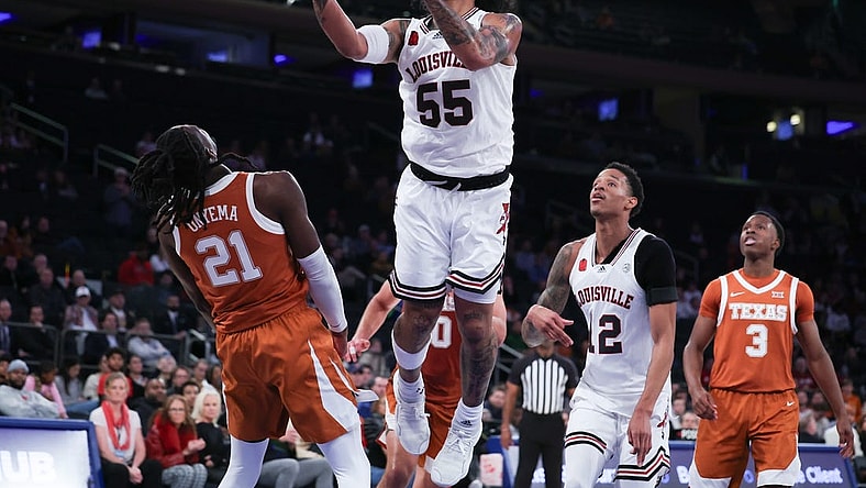 Nov 19, 2023; New York, New York, USA; Louisville Cardinals guard Skyy Clark (55) goes to the basket against Texas Longhorns forward Ze'Rik Onyema (21) during the second half at Madison Square Garden. Mandatory Credit: Vincent Carchietta-USA TODAY Sports