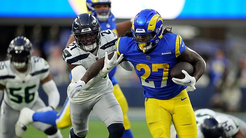 Nov 19, 2023; Inglewood, California, USA; Los Angeles Rams running back Darrell Henderson Jr. (27) runs against Seattle Seahawks cornerback Devon Witherspoon (21) in the second half at SoFi Stadium. Mandatory Credit: Kirby Lee-USA TODAY Sports