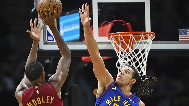 Nov 19, 2023; Cleveland, Ohio, USA; Cleveland Cavaliers forward Evan Mobley (4) shoots beside Denver Nuggets forward Aaron Gordon (50) in the second quarter at Rocket Mortgage FieldHouse. Mandatory Credit: David Richard-USA TODAY Sports