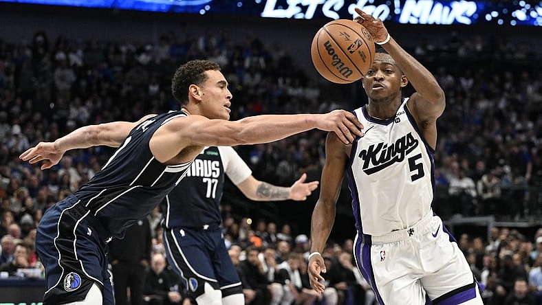 Nov 19, 2023; Dallas, Texas, USA;Dallas Mavericks center Dwight Powell (7) and Sacramento Kings guard De'Aaron Fox (5) battle for control of a loose ball during the second quarter at the American Airlines Center. Mandatory Credit: Jerome Miron-USA TODAY Sports