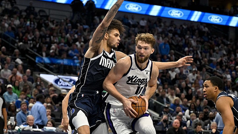 Nov 19, 2023; Dallas, Texas, USA; Sacramento Kings forward Domantas Sabonis (10) looks to move to the basket past Dallas Mavericks center Dereck Lively II (2) during the second half at the American Airlines Center. Mandatory Credit: Jerome Miron-USA TODAY Sports