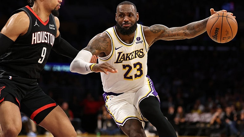 Nov 19, 2023; Los Angeles, California, USA;  Los Angeles Lakers forward LeBron James (23) dribbles against Houston Rockets forward Dillon Brooks (9) during the second quarter at Crypto.com Arena. Mandatory Credit: Kiyoshi Mio-USA TODAY Sports