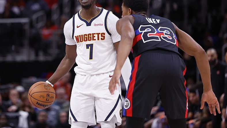 Nov 20, 2023; Detroit, Michigan, USA;  Denver Nuggets guard Reggie Jackson (7) dribbles defended by Detroit Pistons guard Jaden Ivey (23) in the first half at Little Caesars Arena. Mandatory Credit: Rick Osentoski-USA TODAY Sports