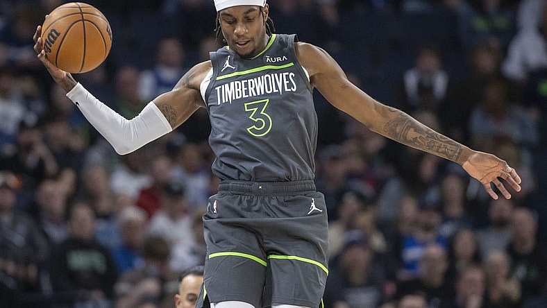 Nov 20, 2023; Minneapolis, Minnesota, USA; Minnesota Timberwolves forward Jaden McDaniels (3) jumps up to save a loose ball against the New York Knicks in the first half at Target Center. Mandatory Credit: Jesse Johnson-USA TODAY Sports