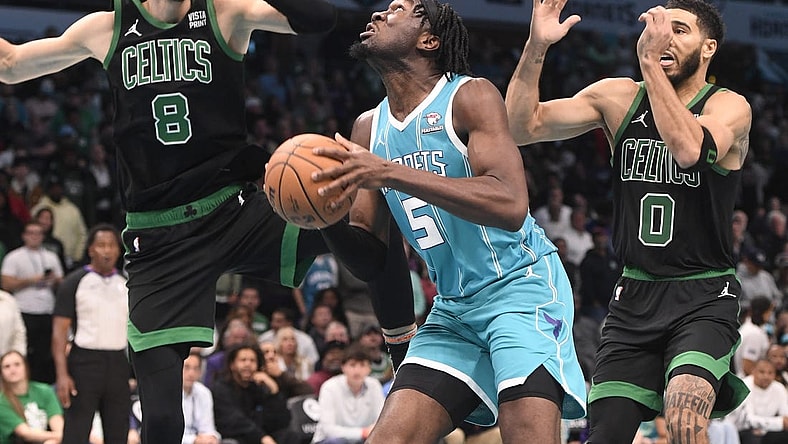 Nov 20, 2023; Charlotte, North Carolina, USA; Charlotte Hornets Center Mark Williams (5) looks to shoot as he is defended by Boston Celtics forward center Kristaps Porzingis (8) and forward Jayson Tatum (0) during the second half at the Spectrum Center. Mandatory Credit: Sam Sharpe-USA TODAY Sports