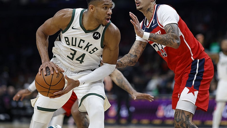 Nov 20, 2023; Washington, District of Columbia, USA; Milwaukee Bucks forward Giannis Antetokounmpo (34) drives to the basket as Washington Wizards forward Kyle Kuzma (33) defends in the fourth quarter at Capital One Arena. Mandatory Credit: Geoff Burke-USA TODAY Sports