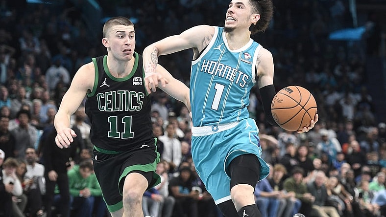 Nov 20, 2023; Charlotte, North Carolina, USA; Charlotte Hornets guard LaMelo Ball (1) drives past Boston Celtics guard Payton Pritchard (11) during the second half at the Spectrum Center. Mandatory Credit: Sam Sharpe-USA TODAY Sports