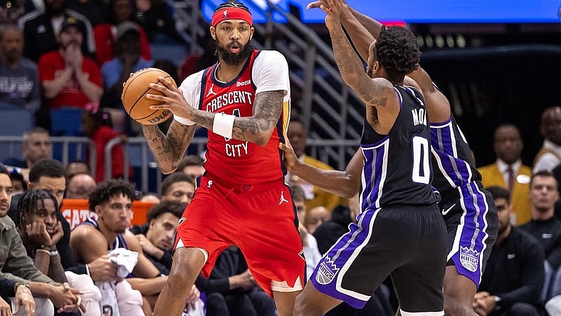 Nov 20, 2023; New Orleans, Louisiana, USA;  New Orleans Pelicans forward Brandon Ingram (14) looks to pass the ball against Sacramento Kings guard Malik Monk (0) during the second half at the Smoothie King Center. Mandatory Credit: Stephen Lew-USA TODAY Sports