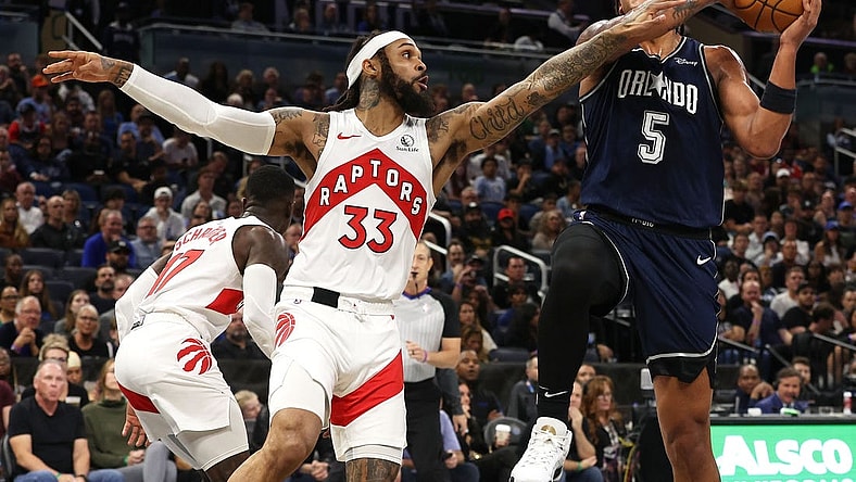 Nov 21, 2023; Orlando, Florida, USA; Orlando Magic forward Paolo Banchero (5) shoots as Toronto Raptors guard Gary Trent Jr. (33) defends during the first quarter at Amway Center. Mandatory Credit: Kim Klement Neitzel-USA TODAY Sports