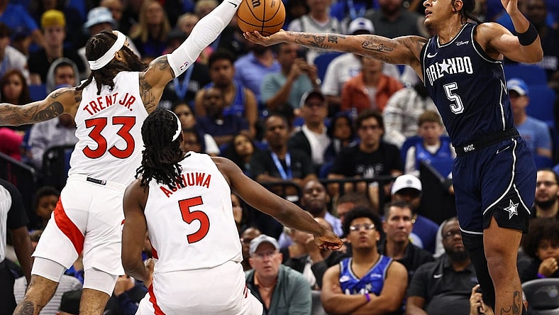 Nov 21, 2023; Orlando, Florida, USA; Toronto Raptors guard Gary Trent Jr. (33) and Orlando Magic forward Paolo Banchero (5) go after the basket during the second half at Amway Center. Mandatory Credit: Kim Klement Neitzel-USA TODAY Sports