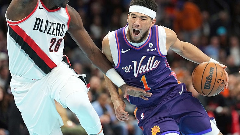 Nov 21, 2023; Phoenix, Arizona, USA; Phoenix Suns guard Devin Booker (1) dribbles against Portland Trail Blazers center Duop Reath (26) during the first half at Footprint Center. Mandatory Credit: Joe Camporeale-USA TODAY Sports